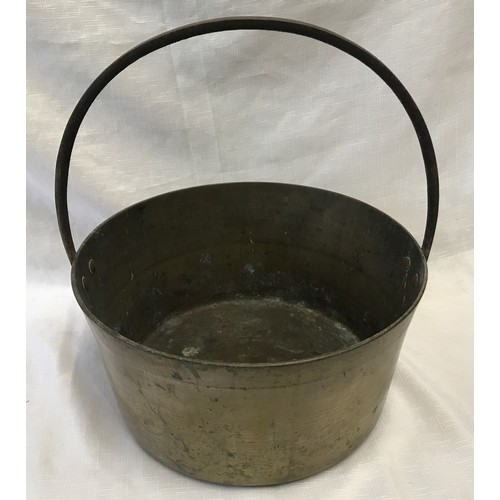 962 - A large brass jam pan with iron handle. 36cm d.