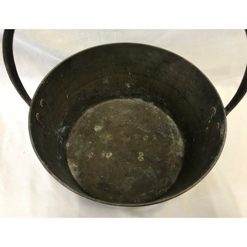 962 - A large brass jam pan with iron handle. 36cm d.