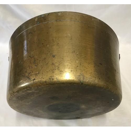 962 - A large brass jam pan with iron handle. 36cm d.