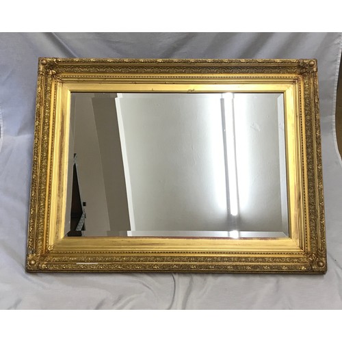 963 - Large decorative gilt framed bevel edged wall mirror.
Mirror size 70cm x 47cm. Frame size 91cm x 68c... 