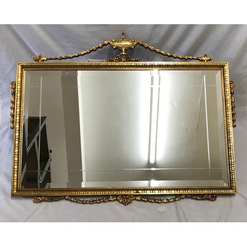 964 - Large decorative gilt framed bevel edged wall mirror with decorative bow frame.
 Mirror size 87cm x ... 