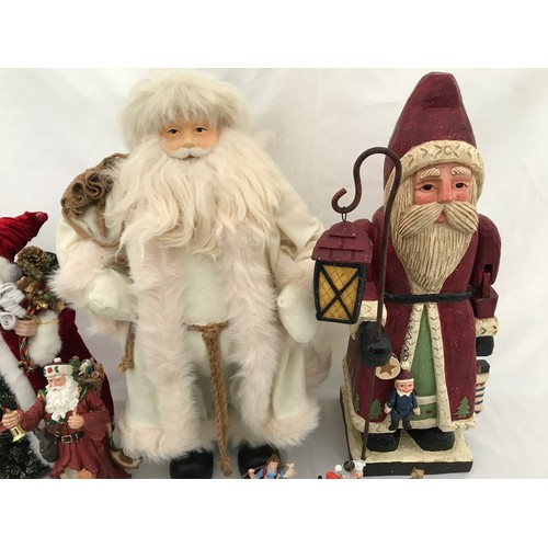 971 - Christmas decorations to include a large wooden Santa 60cm, a Santa in a white coat 62cm, a small Sa... 