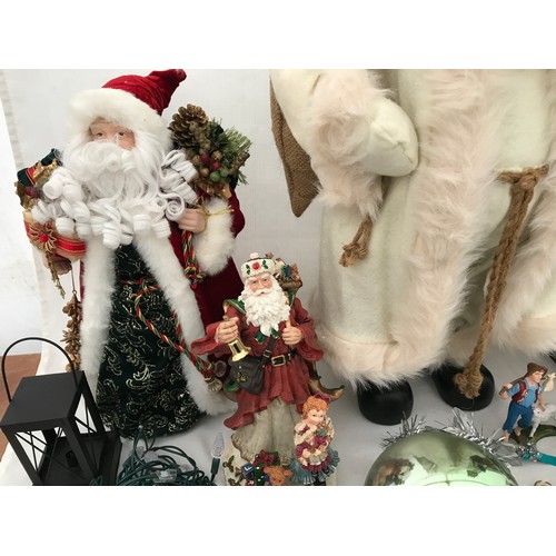 971 - Christmas decorations to include a large wooden Santa 60cm, a Santa in a white coat 62cm, a small Sa... 