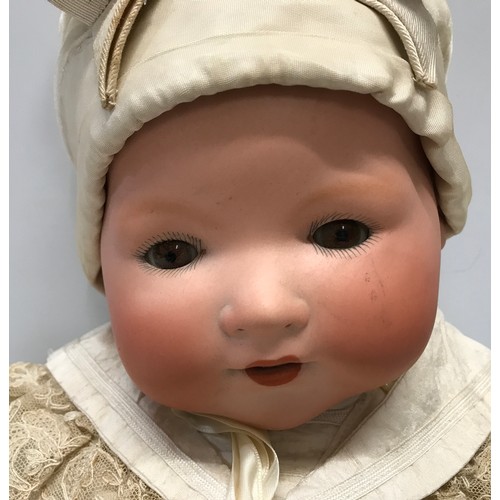 977 - An A.M. Germany pot headed doll with composite body, open/close eyes approx 53cm h. Stamped to the b... 