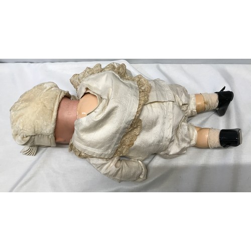 977 - An A.M. Germany pot headed doll with composite body, open/close eyes approx 53cm h. Stamped to the b... 