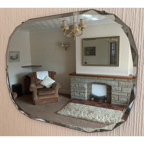 1050 - A mid C20th frameless wall mirror. 46cm h x 61cm w.