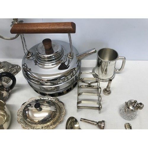 1051 - A collection of silver plate wares to include a candelabra 28cm, teapot, muffin dish, toast rack, la... 