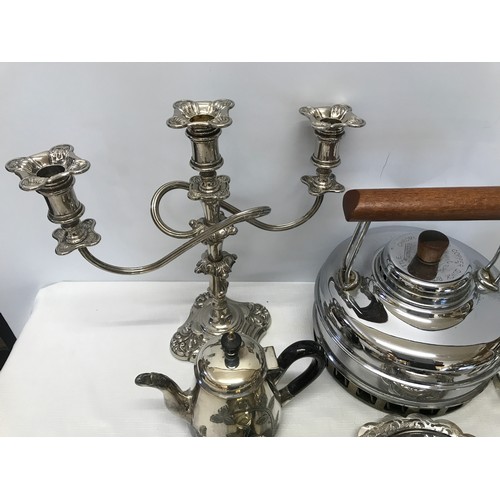 1051 - A collection of silver plate wares to include a candelabra 28cm, teapot, muffin dish, toast rack, la... 