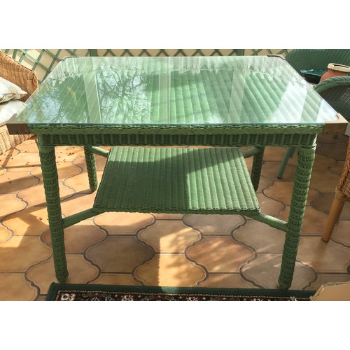 1482 - A green loom table with glazed top. 61 x 92 x 72cms h.