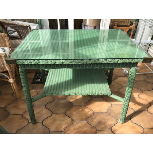 1482 - A green loom table with glazed top. 61 x 92 x 72cms h.