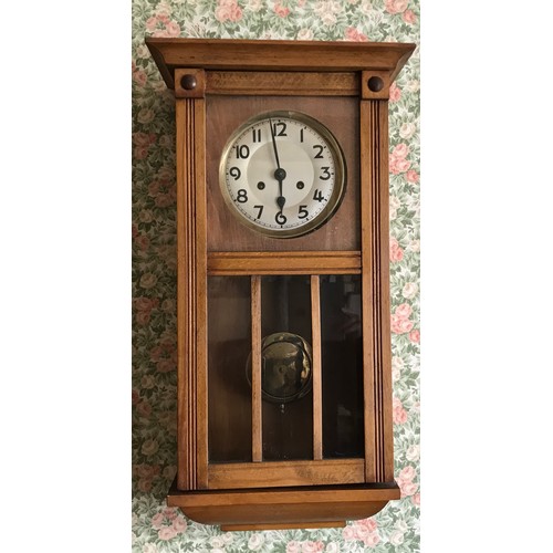 1483 - Oak wall clock with visible brass pendulum. 68 x 32 x 17cms d.