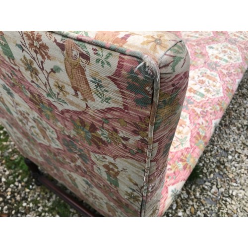 1503 - A mahogany framed floral upholstered wing back sofa. 200 w x 65 d x 90cms h.