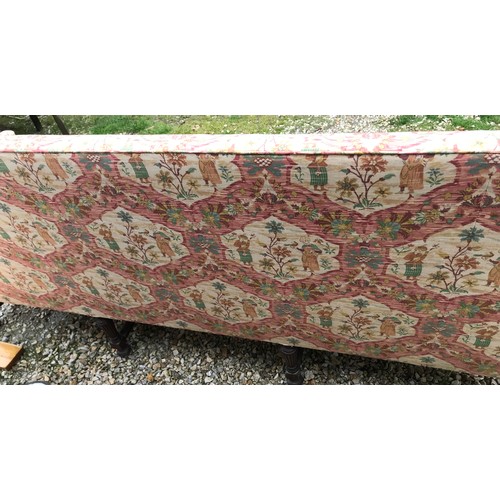 1503 - A mahogany framed floral upholstered wing back sofa. 200 w x 65 d x 90cms h.