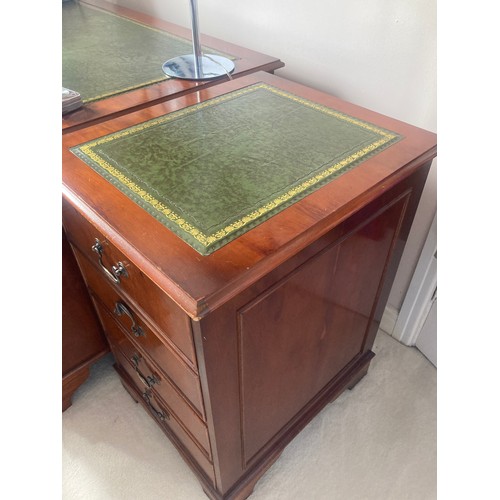 1504 - A 20thC yew wood pedestal desk with green tool leathered top and brass drop handles  and drawers to ... 