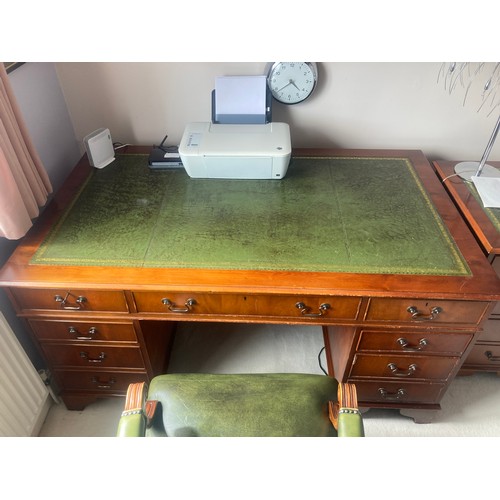 1504 - A 20thC yew wood pedestal desk with green tool leathered top and brass drop handles  and drawers to ... 