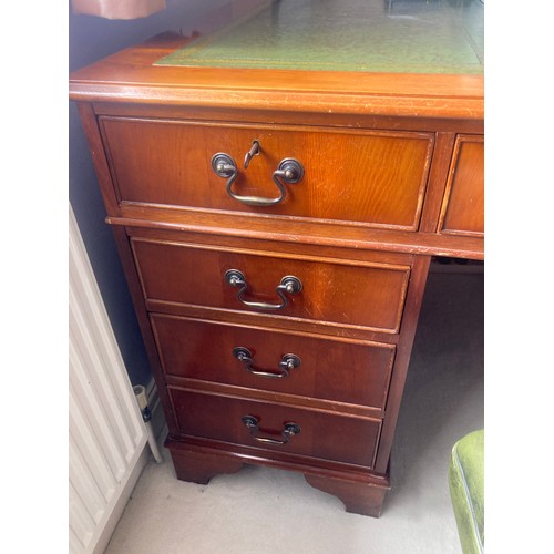 1504 - A 20thC yew wood pedestal desk with green tool leathered top and brass drop handles  and drawers to ... 