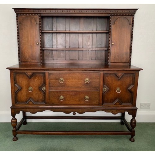 1507 - An oak two height dresser, cupboards and drawers to base, shelves and cupboards to top. 159 h x 152 ... 