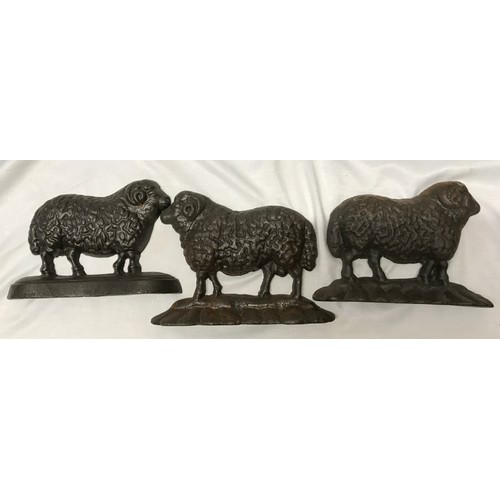 1513 - A collection of cast iron to include three sheep door stops 23.5cm l x 16.5cm w x 6cm, an ornate boo... 