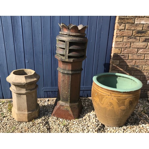 1515 - A tall crowned brown glazed chimney pot 106cm, a small limestone chimney pot 55cm and a large stonew... 