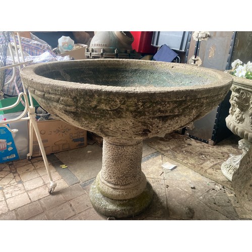 1516 - A large reconstituted stone bird bath on a pedestal base. 80cms x 64cms h.