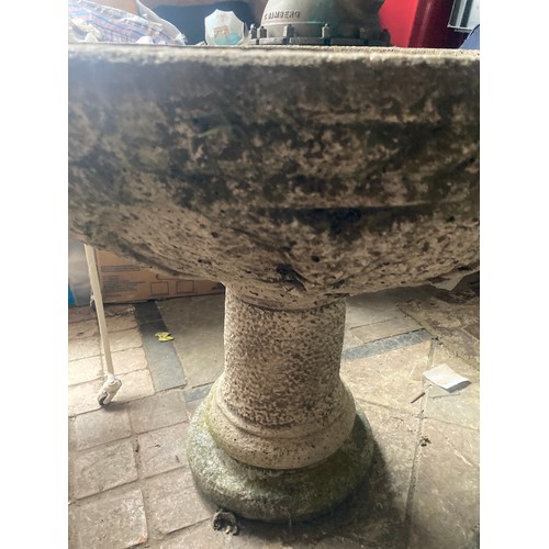 1516 - A large reconstituted stone bird bath on a pedestal base. 80cms x 64cms h.