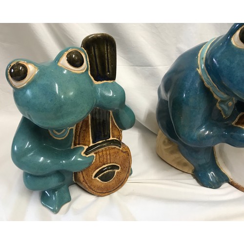 1521 - Large glazed pottery garden ornaments of a frog band x 3 to include saxophone, bass and drum. Talles... 