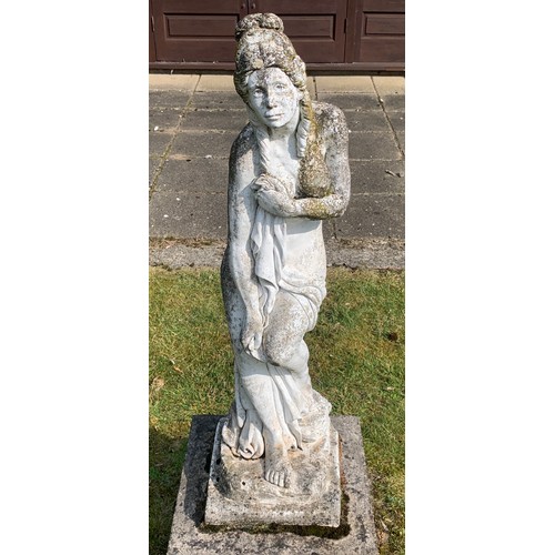 1530 - A reconstituted stone garden ornament of a semi clad female figure.