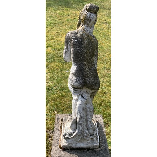 1530 - A reconstituted stone garden ornament of a semi clad female figure.