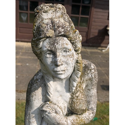 1530 - A reconstituted stone garden ornament of a semi clad female figure.