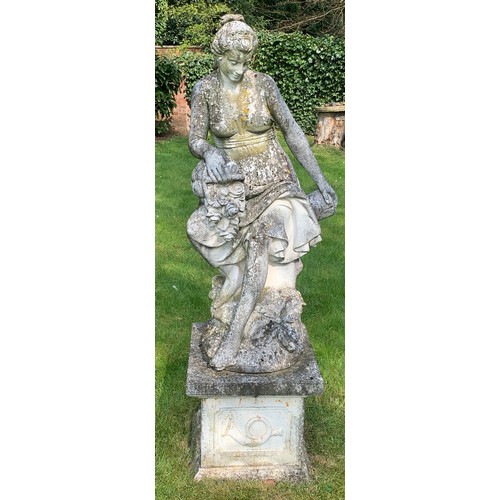 1531 - A reconstituted stone garden ornament of a female figure with flower basket seated on tree stump and... 