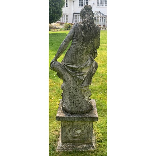 1531 - A reconstituted stone garden ornament of a female figure with flower basket seated on tree stump and... 