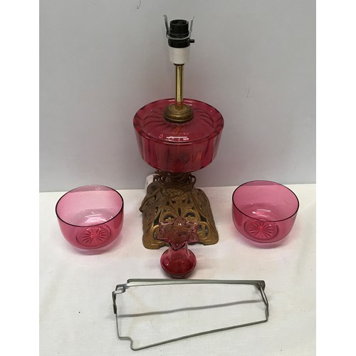 961 - Cranberry glass electrified oil lamp with cast iron base 39 cm H,  two cranberry bowls 11.5 cm w and... 