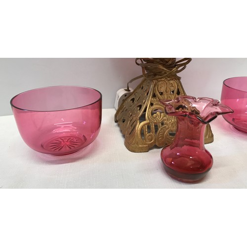 961 - Cranberry glass electrified oil lamp with cast iron base 39 cm H,  two cranberry bowls 11.5 cm w and... 