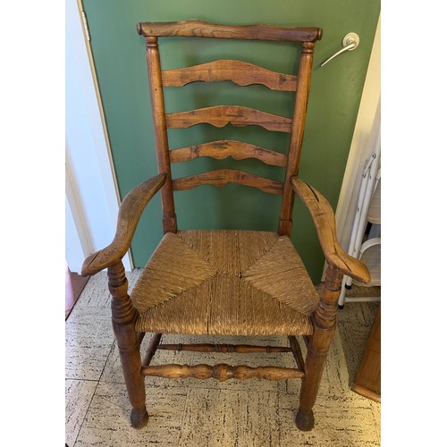 1481A - An 18thC elm ladder back rush seated chair.