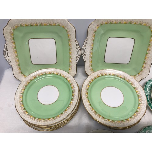 6 - Two part tea sets. Copeland Grosvenor China green and gilt comprising 2 cake plates 24cms, 12 side p... 