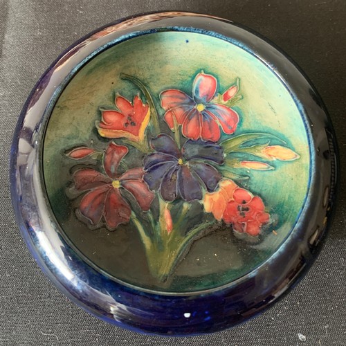 53 - A Moorcroft circular dish, 11.5cms h, blue ground with floral decoration.