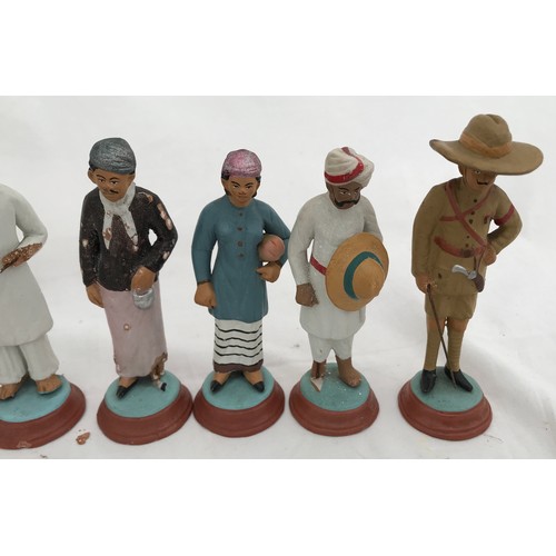 74 - A set of nine Indian clay figurines. Tallest Gurkha 11cms h, smallest lady 9.5cms h.