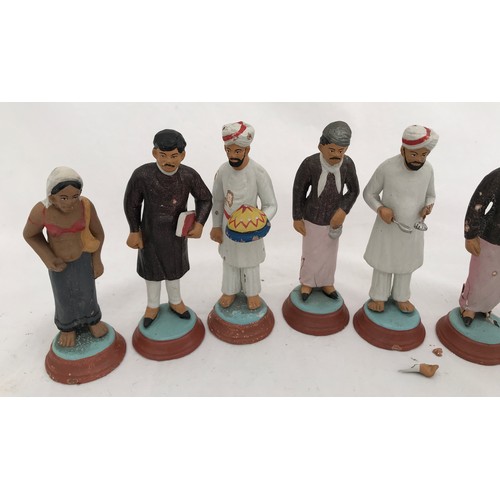 74 - A set of nine Indian clay figurines. Tallest Gurkha 11cms h, smallest lady 9.5cms h.