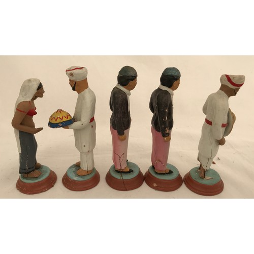 74 - A set of nine Indian clay figurines. Tallest Gurkha 11cms h, smallest lady 9.5cms h.