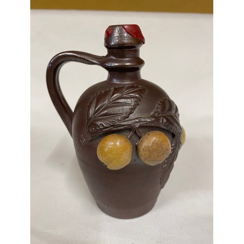 81 - Three pieces of stoneware to include a French Turgis Normandy calvados bottle. Largest 27cms d. Bott... 