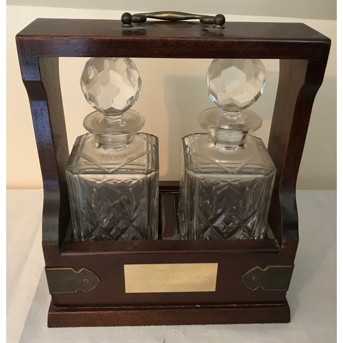 105 - A mahogany cased two bottle tantalus with Royal Doulton crystal glass decanters with key. 29cms h x ... 