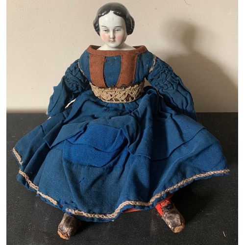 703 - A mid 19thC pot headed doll in cotemporary clothing with pot arms. 30cms l.