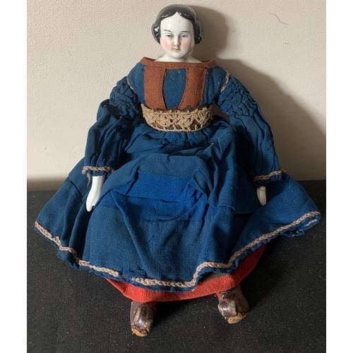 703 - A mid 19thC pot headed doll in cotemporary clothing with pot arms. 30cms l.