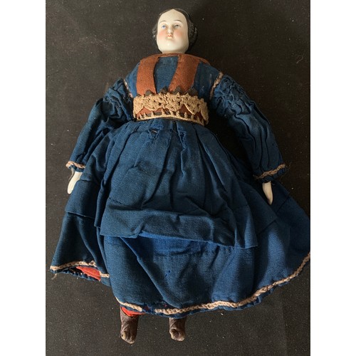 703 - A mid 19thC pot headed doll in cotemporary clothing with pot arms. 30cms l.