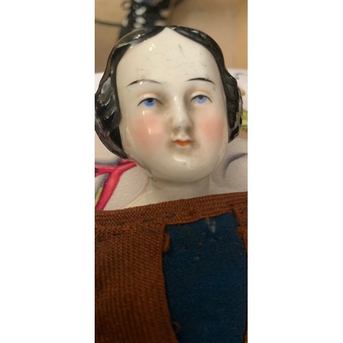 703 - A mid 19thC pot headed doll in cotemporary clothing with pot arms. 30cms l.