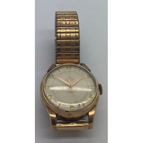 723 - A Smiths deluxe 9ct gentlemen's wristwatch with expanding gilt bracelet. Total weight 54.6gms.