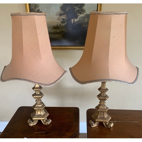 747 - A pair of gilt table lamps with shades. 72cms h.