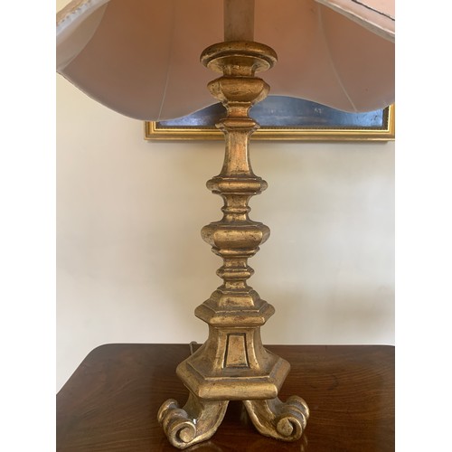 747 - A pair of gilt table lamps with shades. 72cms h.