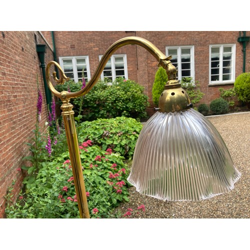 748 - A good quality Edwardian brass standard lamp with clear glass shade. 167cms h.