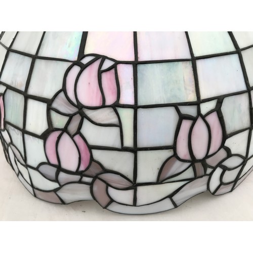 753 - A large Tiffany style pink table lamp shade in a floral design. 52cms w x approx. 33cms h.